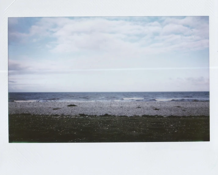 a polaroid po of a sandy shore