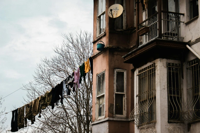 clothes hanging out the window of an apartment building