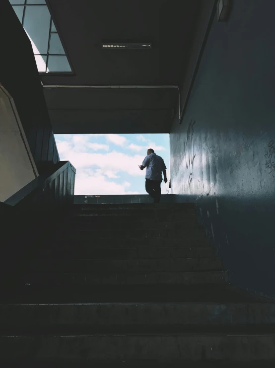 a man climbing up a set of stairs