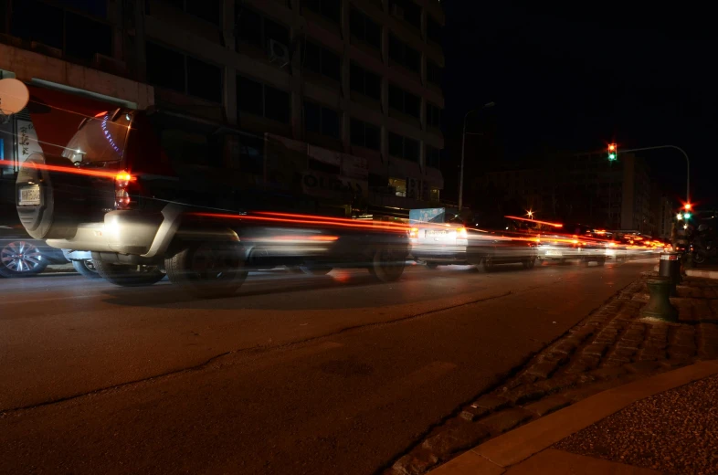 traffic going down a busy city street at night