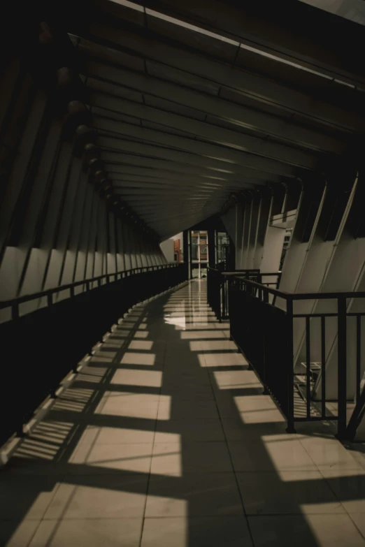 light shines through the shadows of long railing