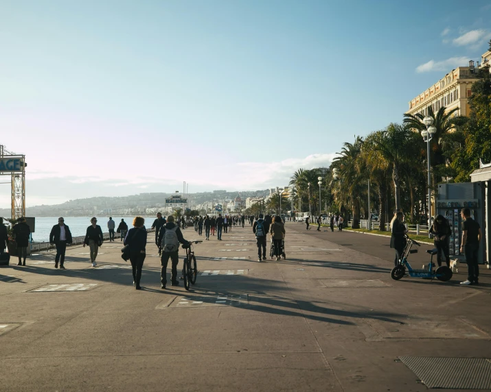 people walk around the streets on a sunny day