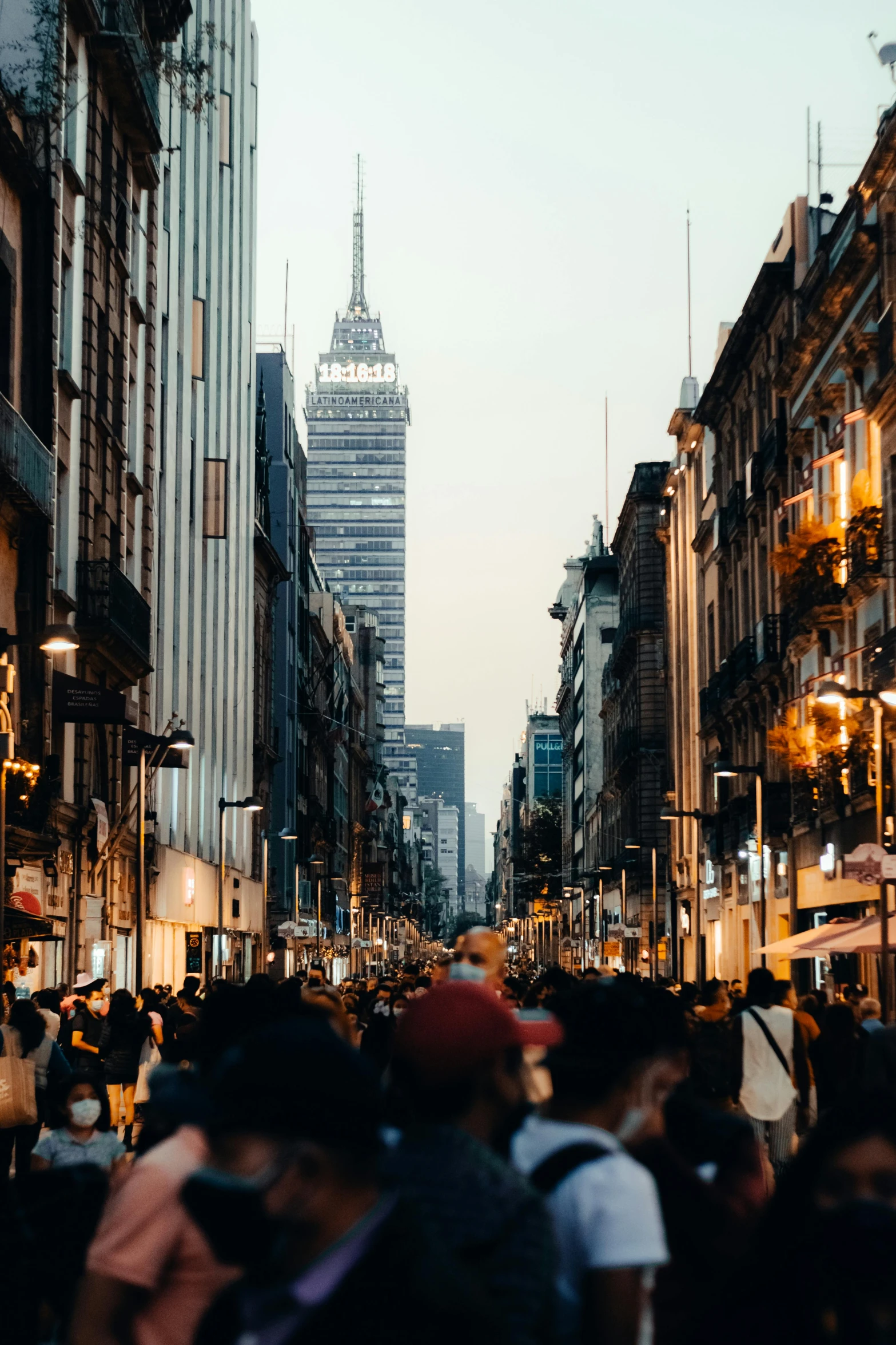 a large group of people standing on a busy street