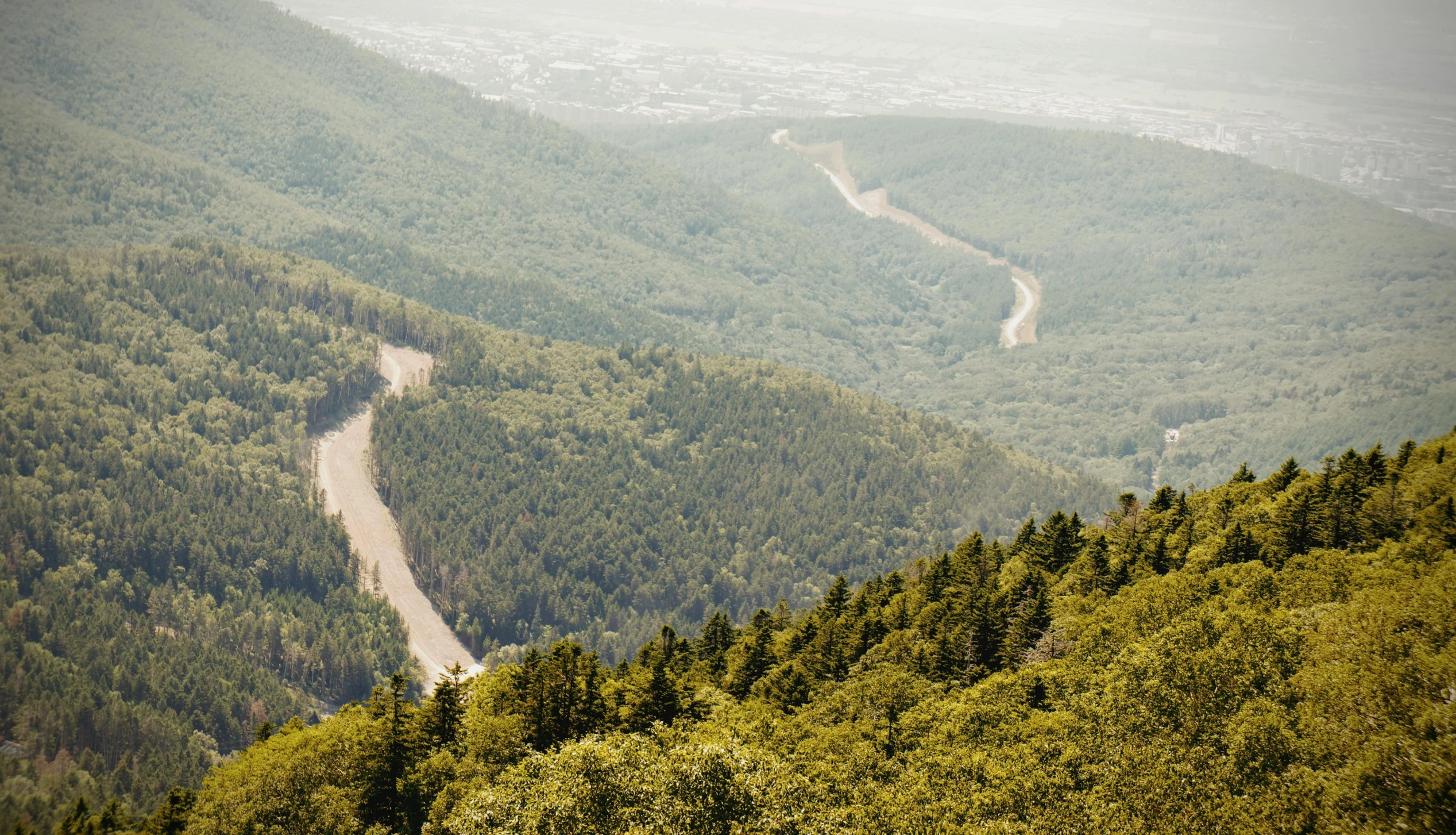 a narrow river winding through a mountainous area