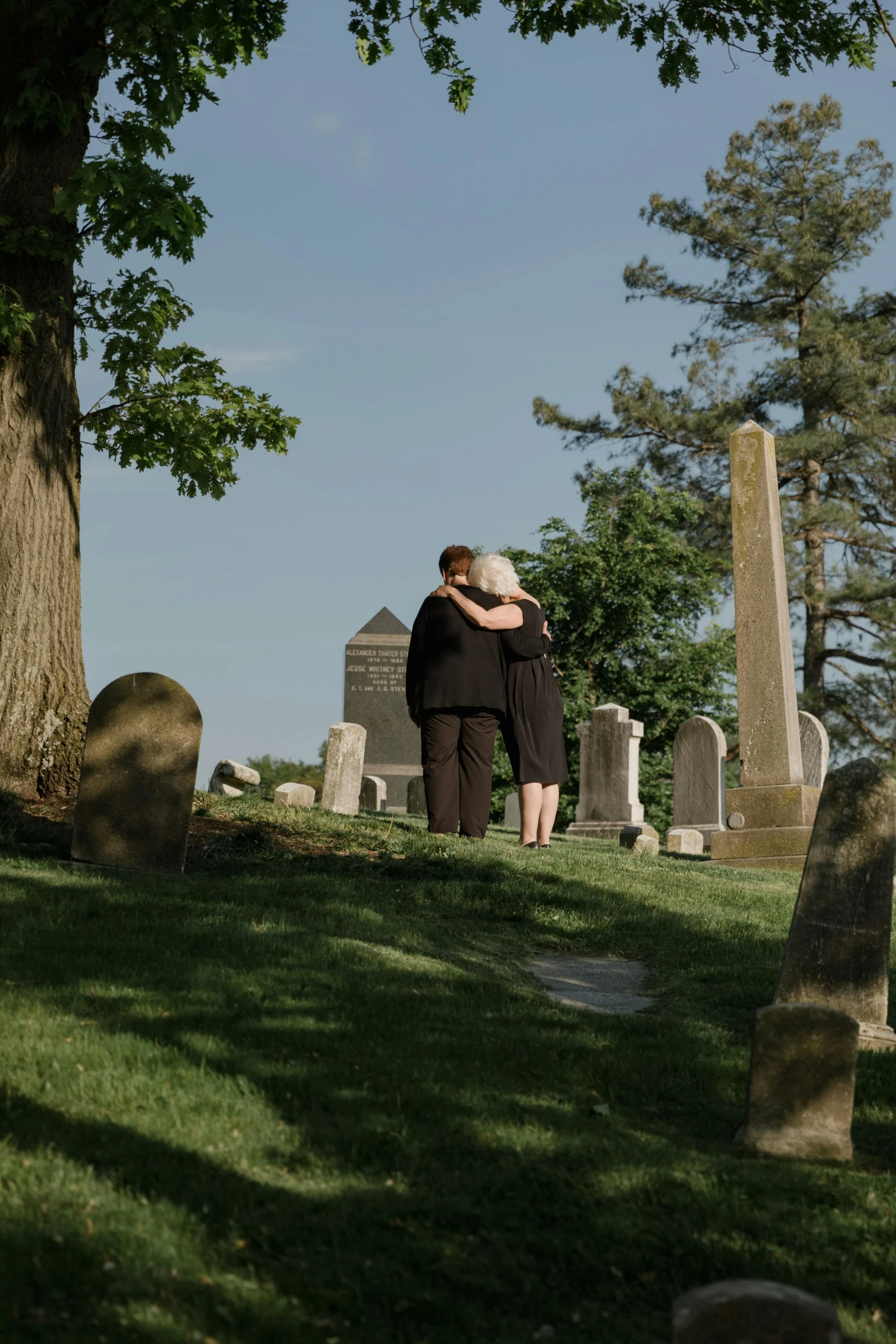 two people emcing in front of headstones