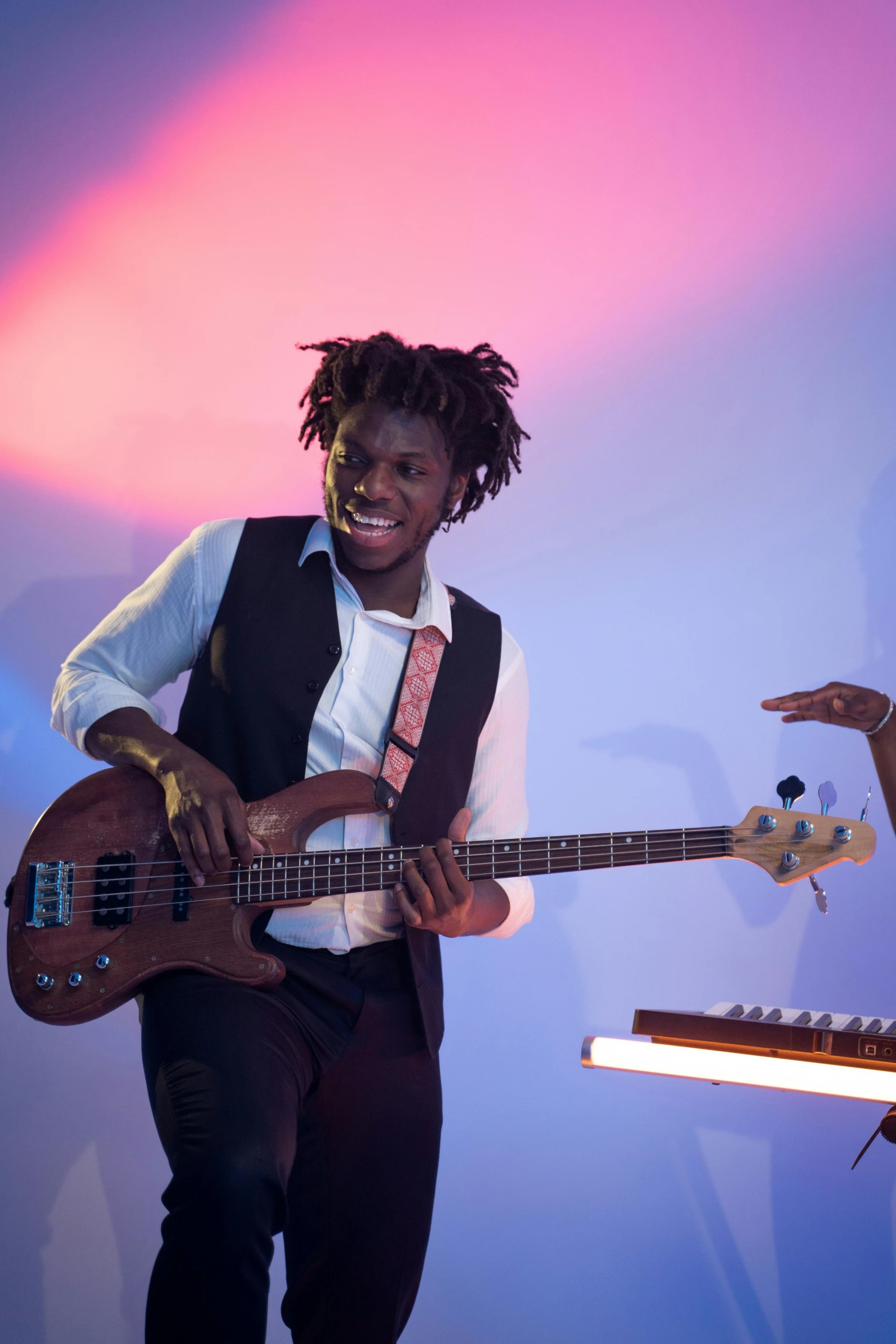 a man playing the guitar with his right arm up