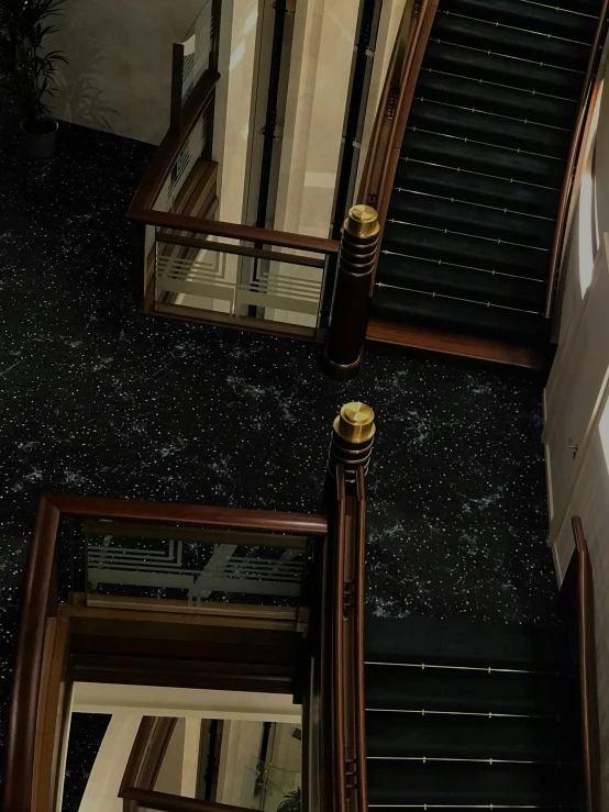 an upward view of stairs and railings in a building