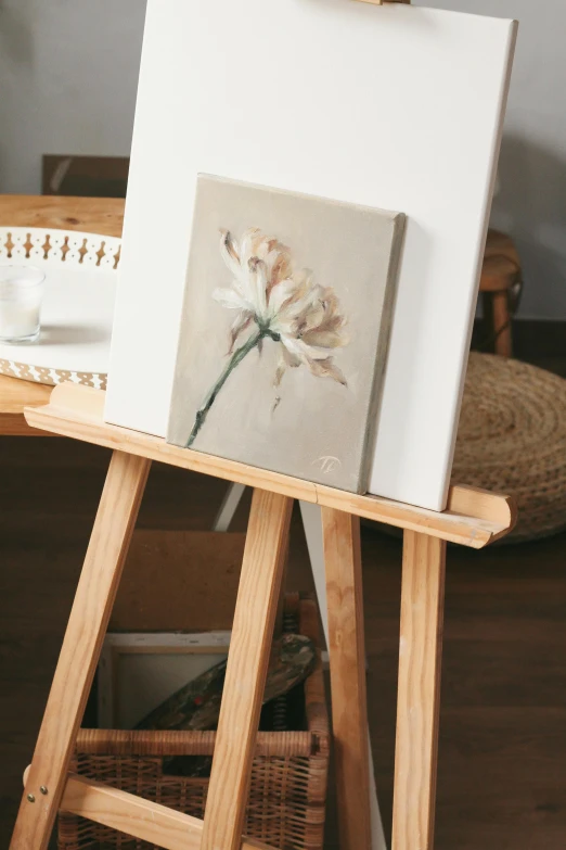 a small painting on easel with flowers inside
