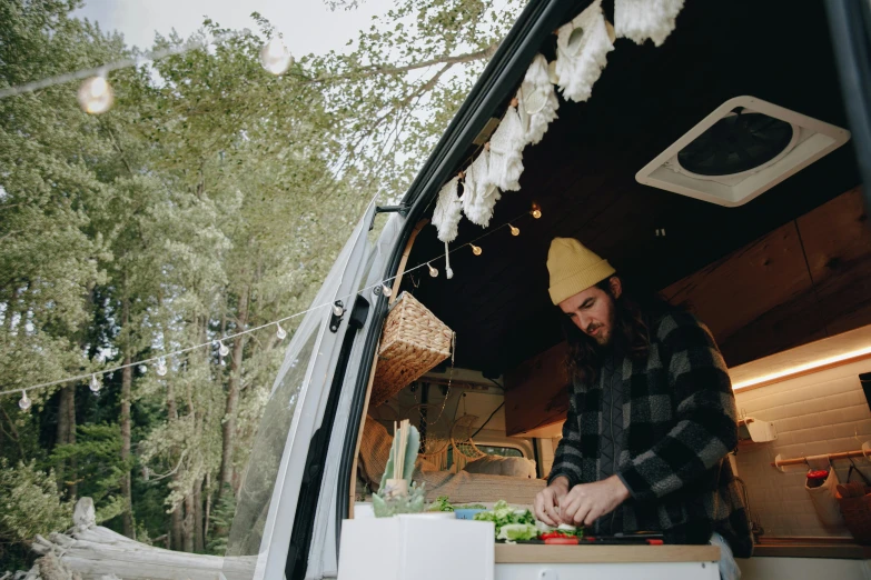 the man is  vegetables in the food truck