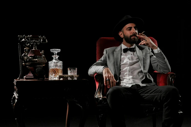 a man sitting in a red chair with cigar