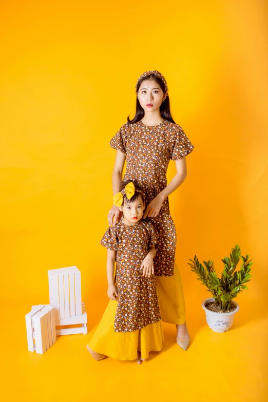 an image of a mother and daughter on a yellow background