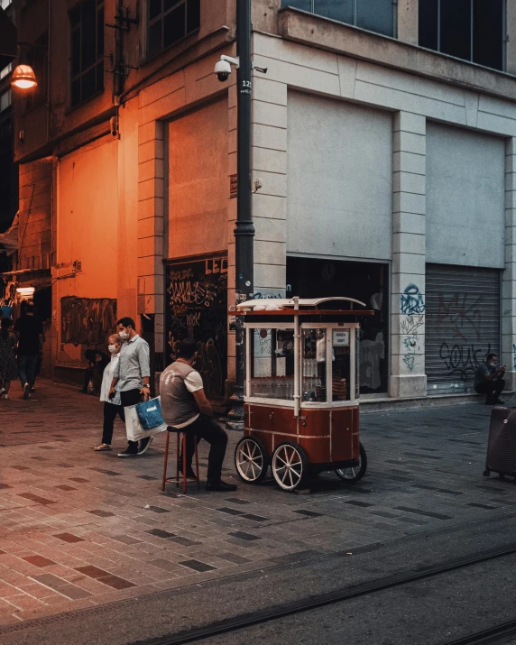 an old cart on the sidewalk with passengers