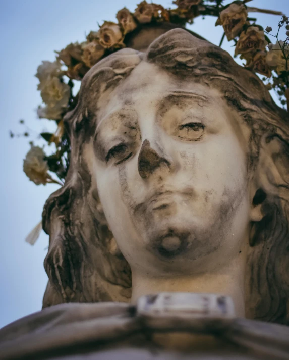 an ornate statue of jesus in the center of a park