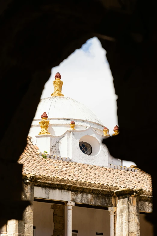 the bell tower has white and yellow tile on it