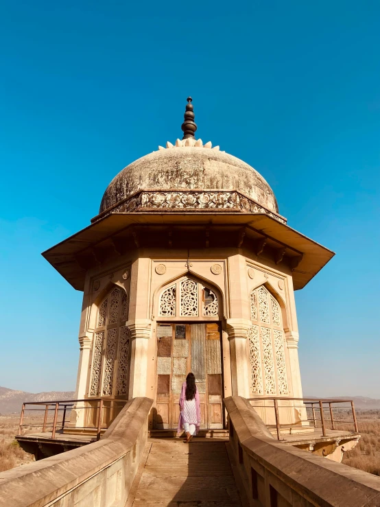 a girl is standing in front of a mosque