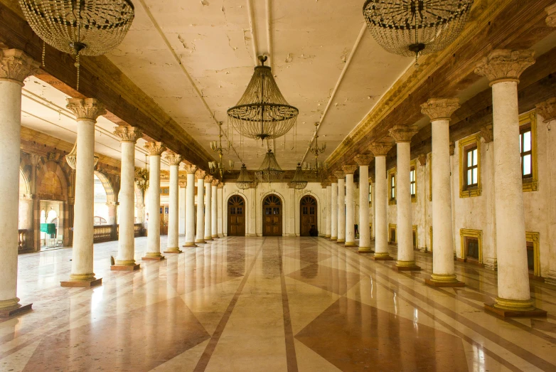 an ornate room has several columns on each wall