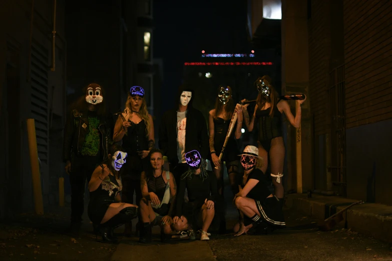 a group of people are wearing neon masks