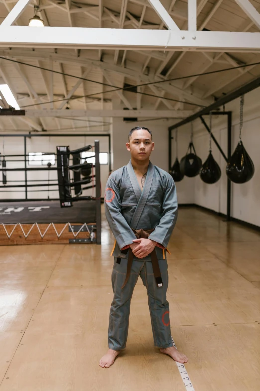 a man is standing in a ring with his hands crossed