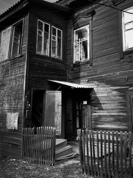 an old wooden building with windows and a door