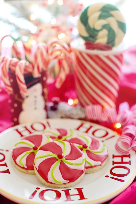 a plate that has cookies on it near christmas decorations