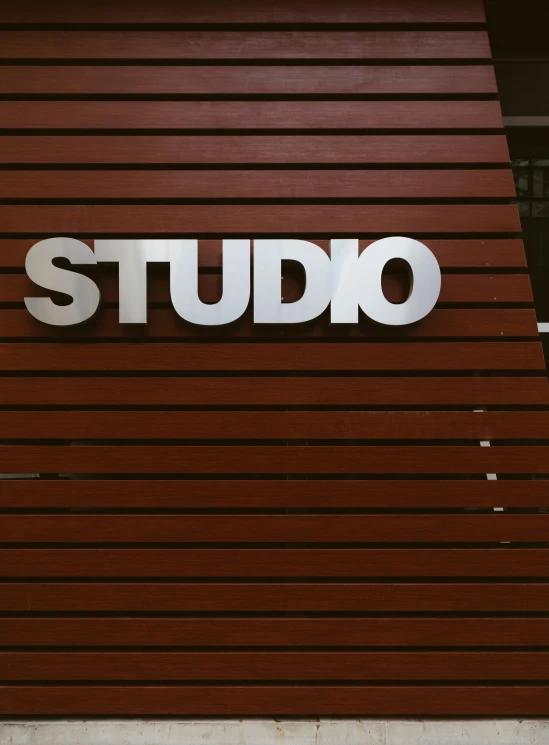 a red and white sign that says studio