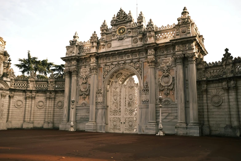 a white archway with a statue in front