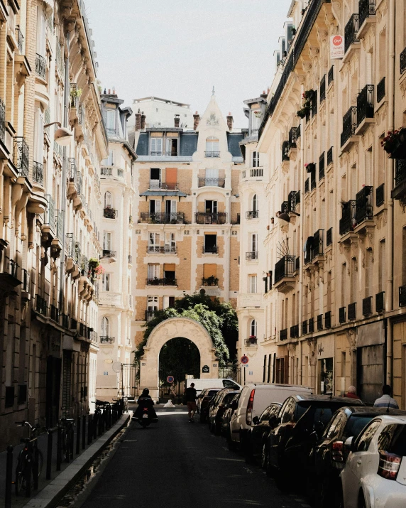 a narrow street with large buildings in the background