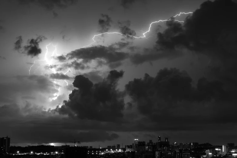 some clouds are in the sky near some city lights