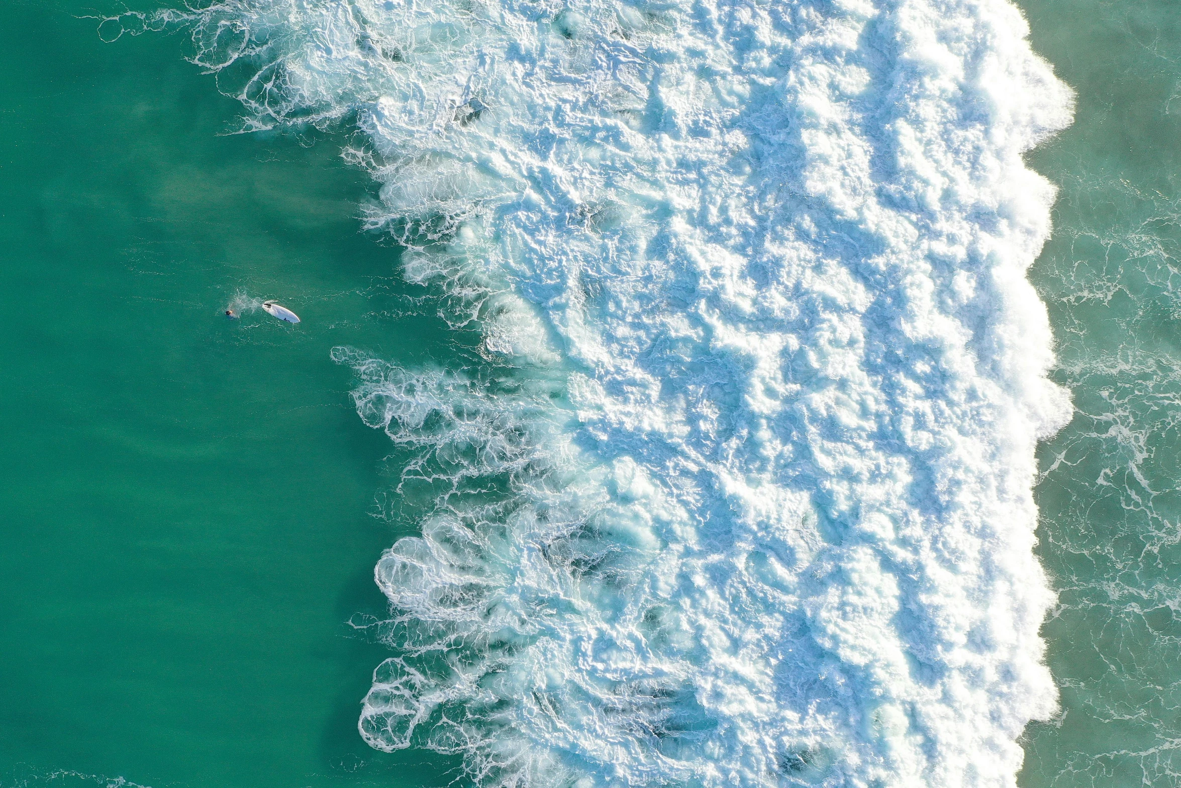 aerial view of a person riding a wave in the water