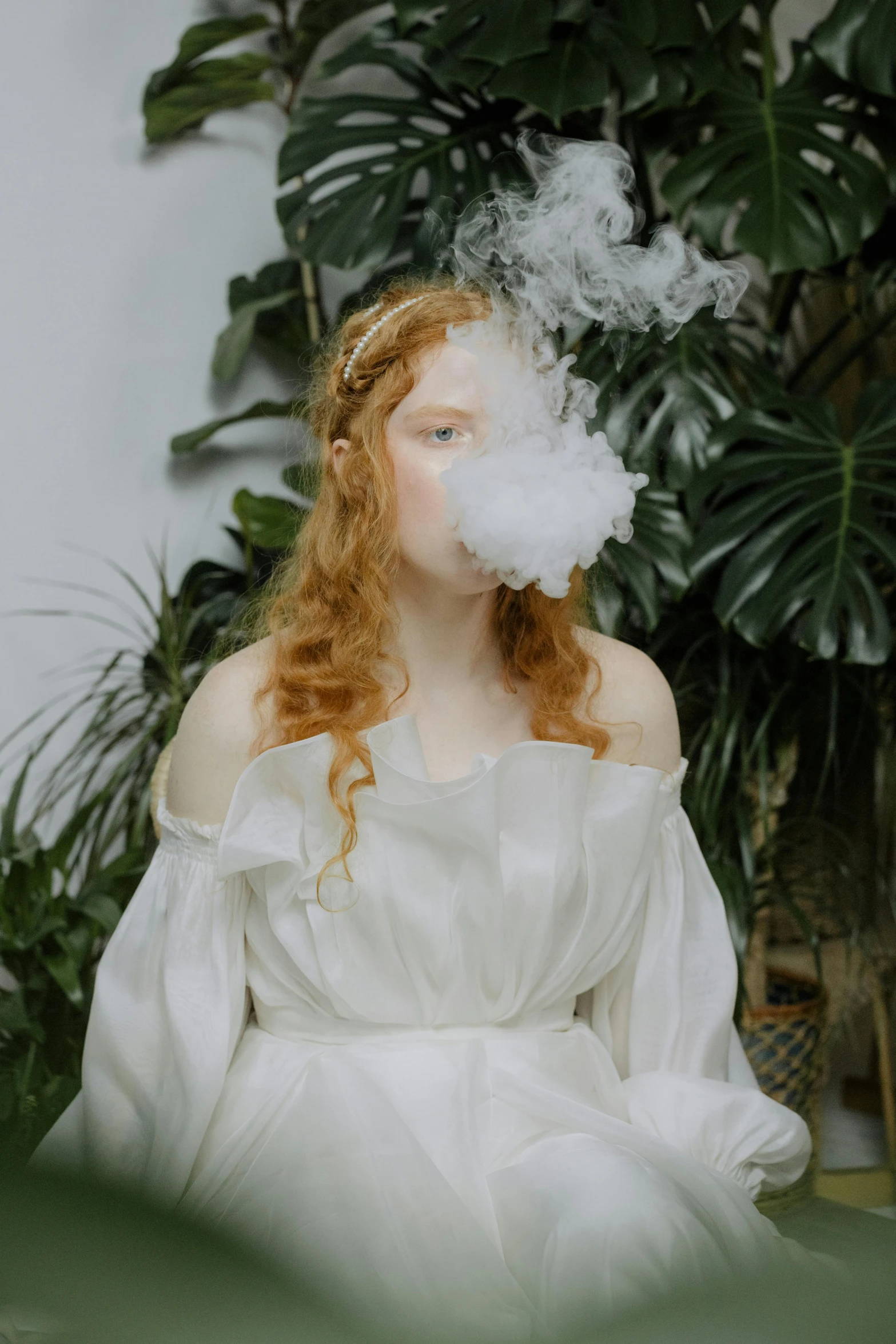 a woman in white smokes from her dress