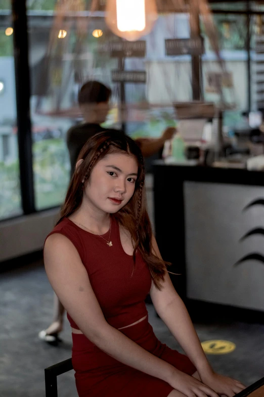 a woman in a red dress posing at a table