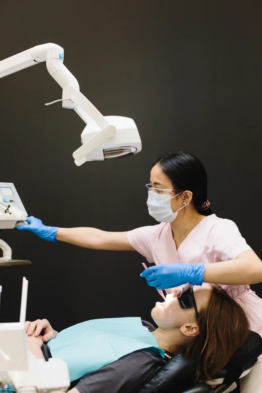 dental technicians performing an important  on a woman