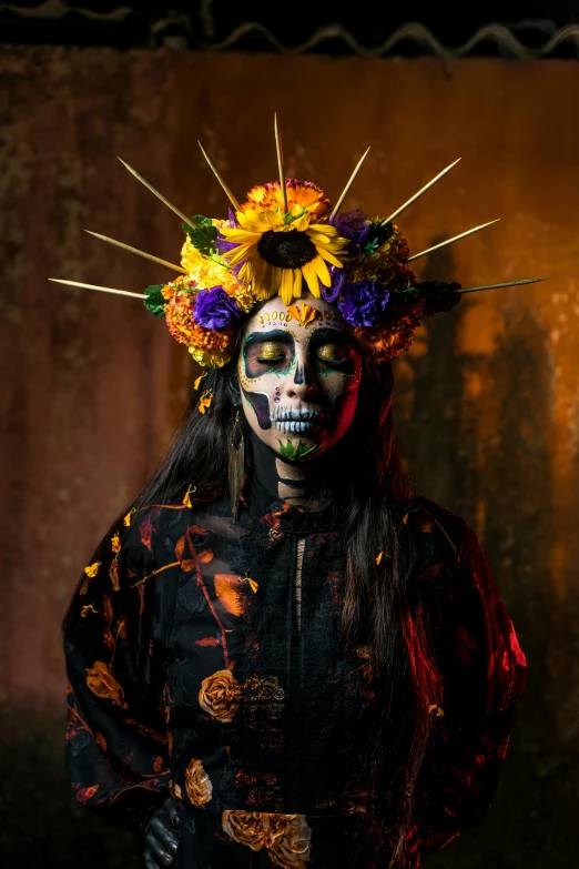 a woman in a decorated headdress poses for a pograph