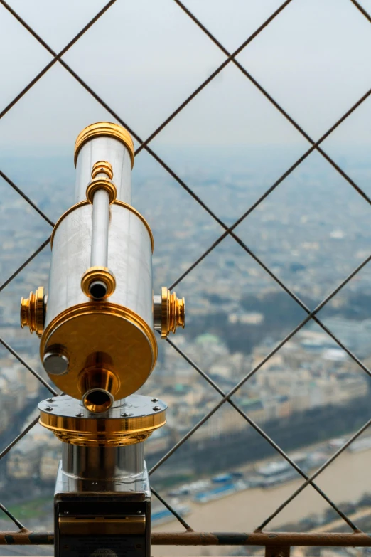 a telescope sits in front of a fenced in area