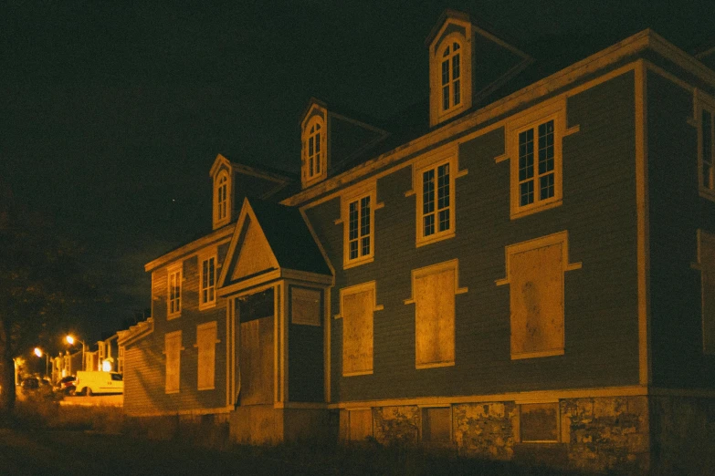 some buildings lit up at night near one another