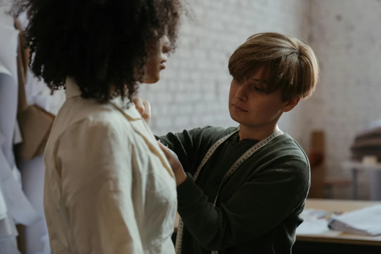 two people are talking to each other in an office