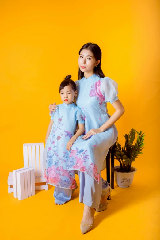 two young women in chinese style dress pose