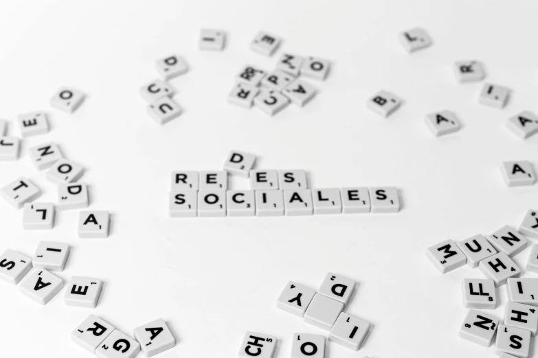 white scrabble tiles spelling word socials