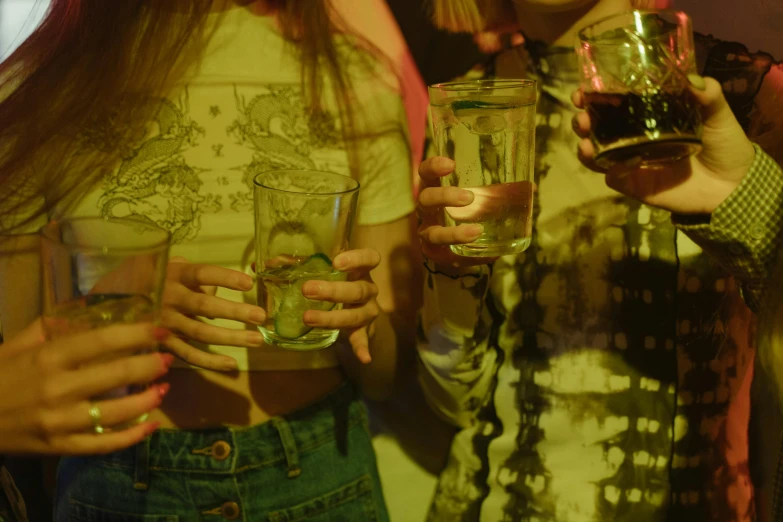 the two ladies are holding the glasses together