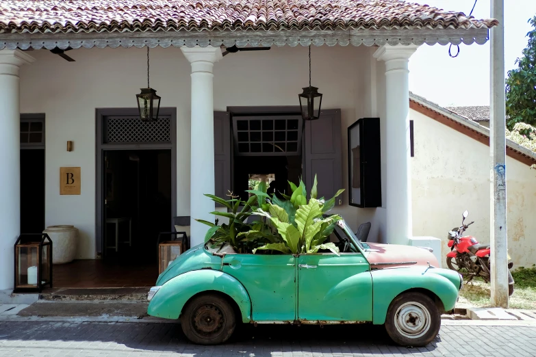 an old fashioned car that is parked outside a house