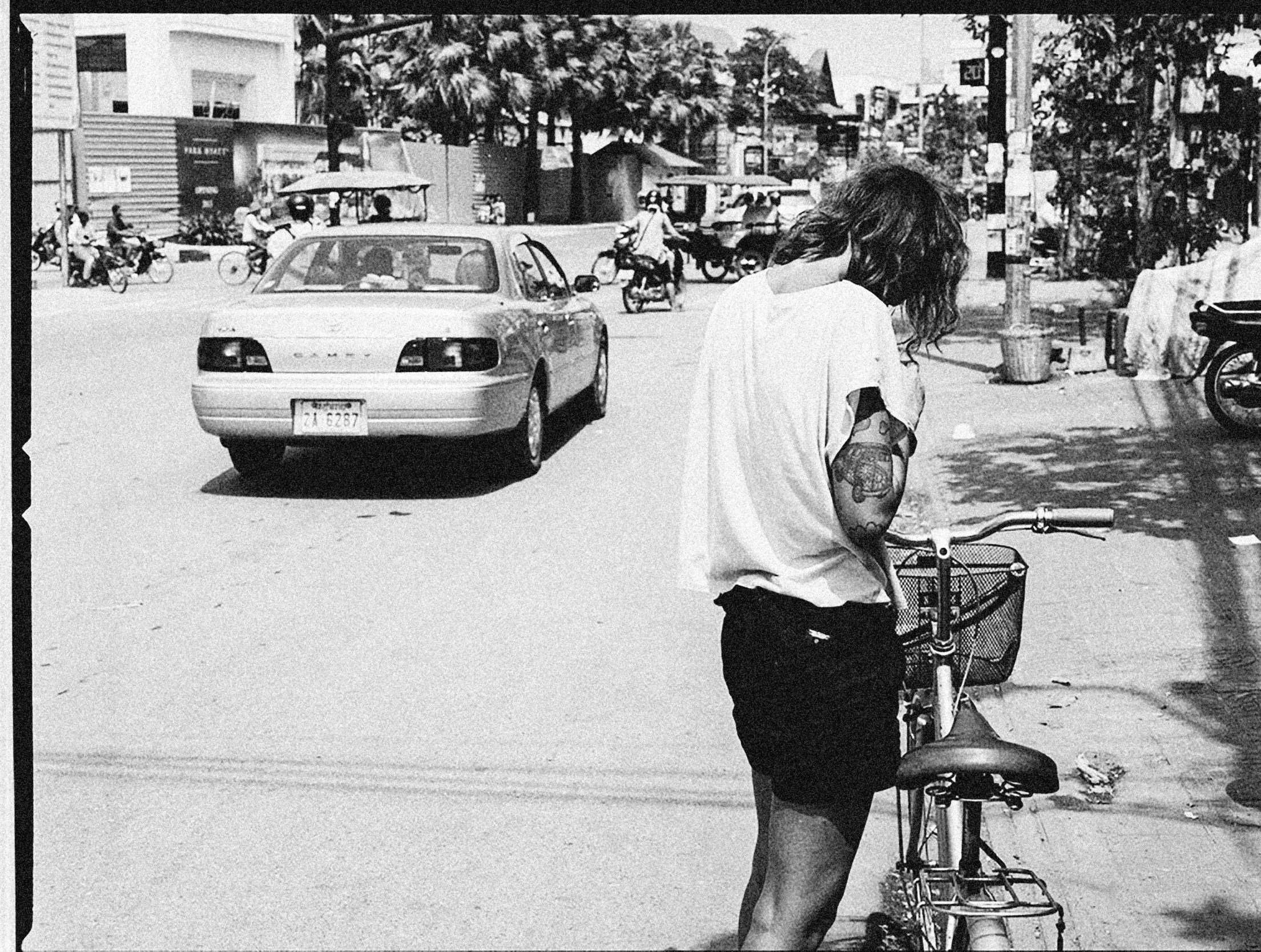 the young man is on his bicycle down the street