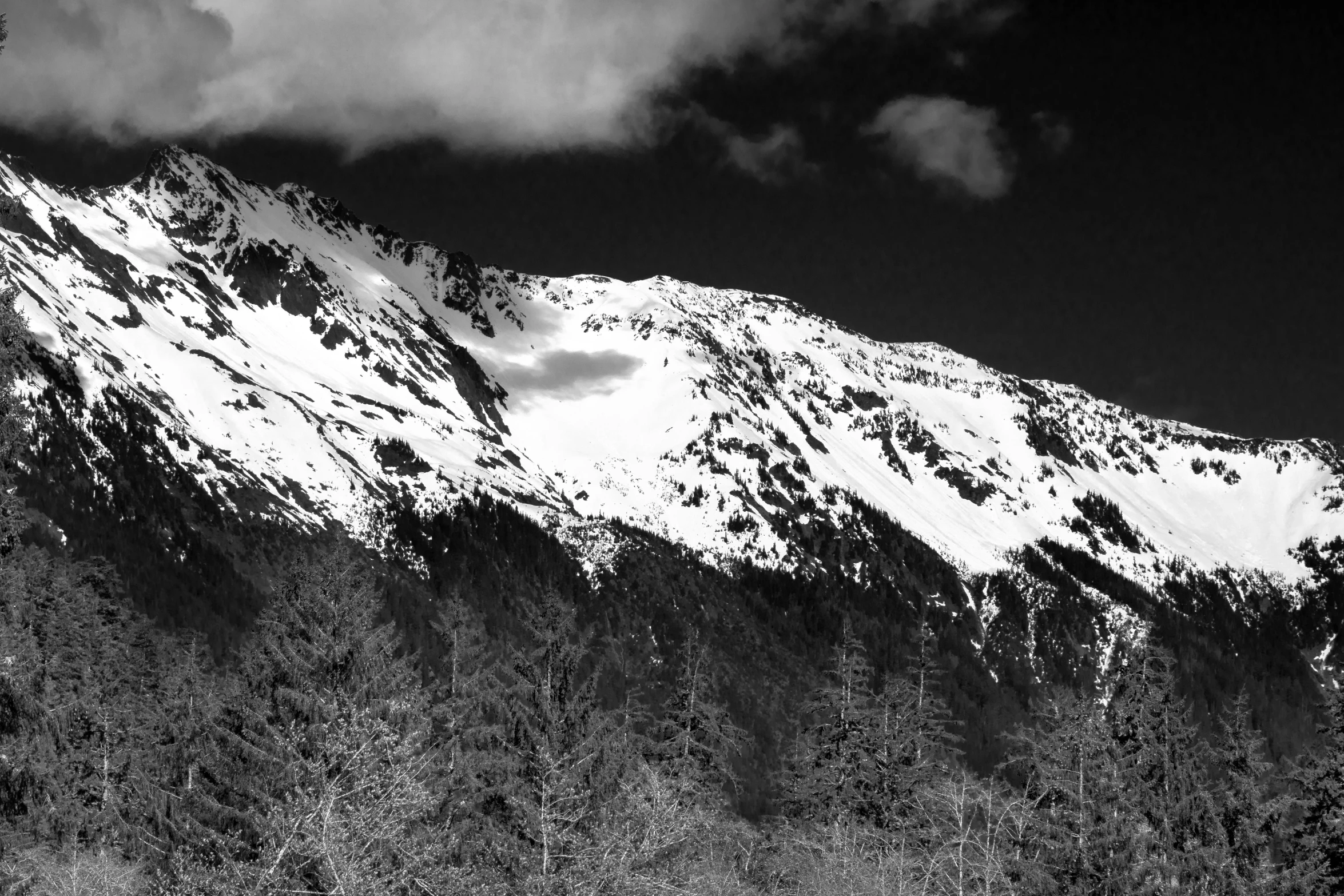 the tops of a mountain covered in snow