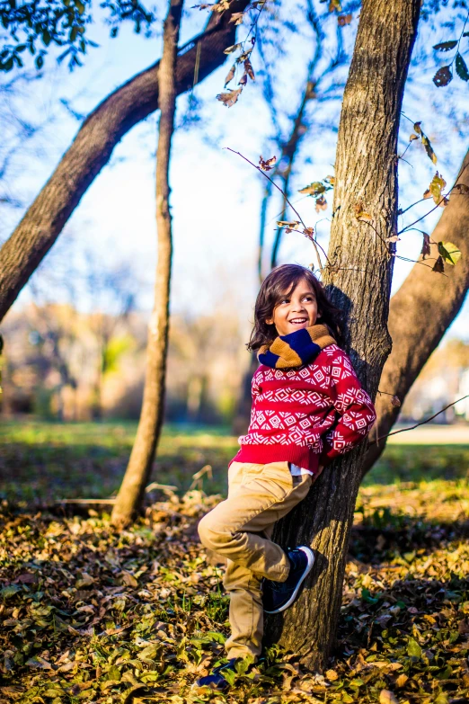 the young child is playing on the tree