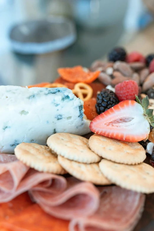 a tray full of food including ers, fruit and cheese