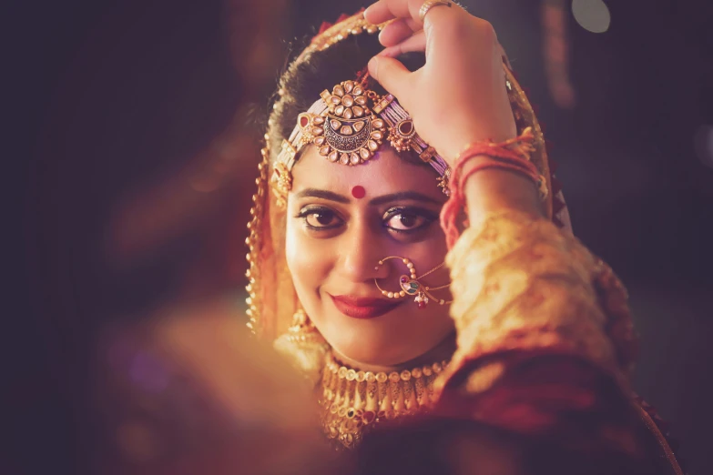 woman wearing traditional wedding wear on the forehead and head