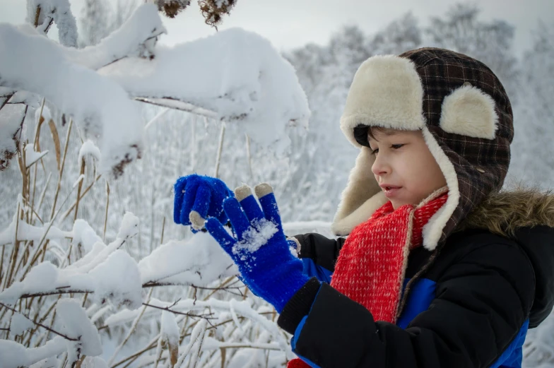 a child holding her snow gloves in their hands