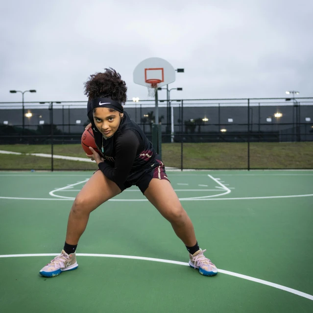 a person standing on a tennis court holding a tennis racquet