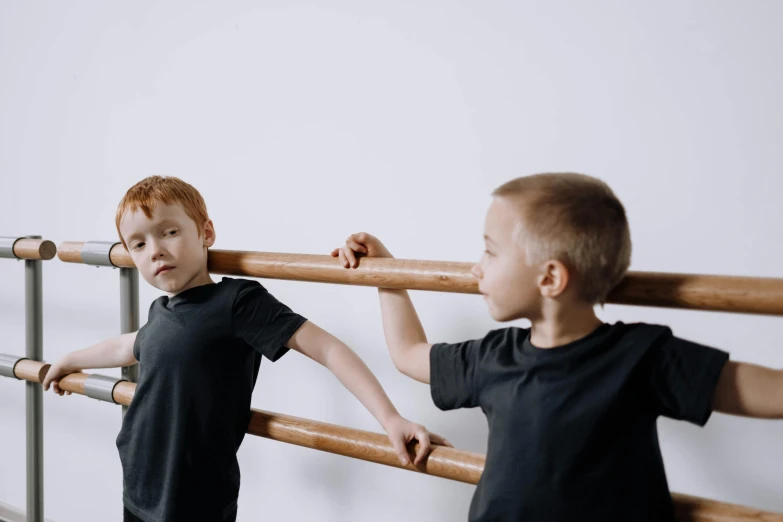 two children playing with large wooden poles