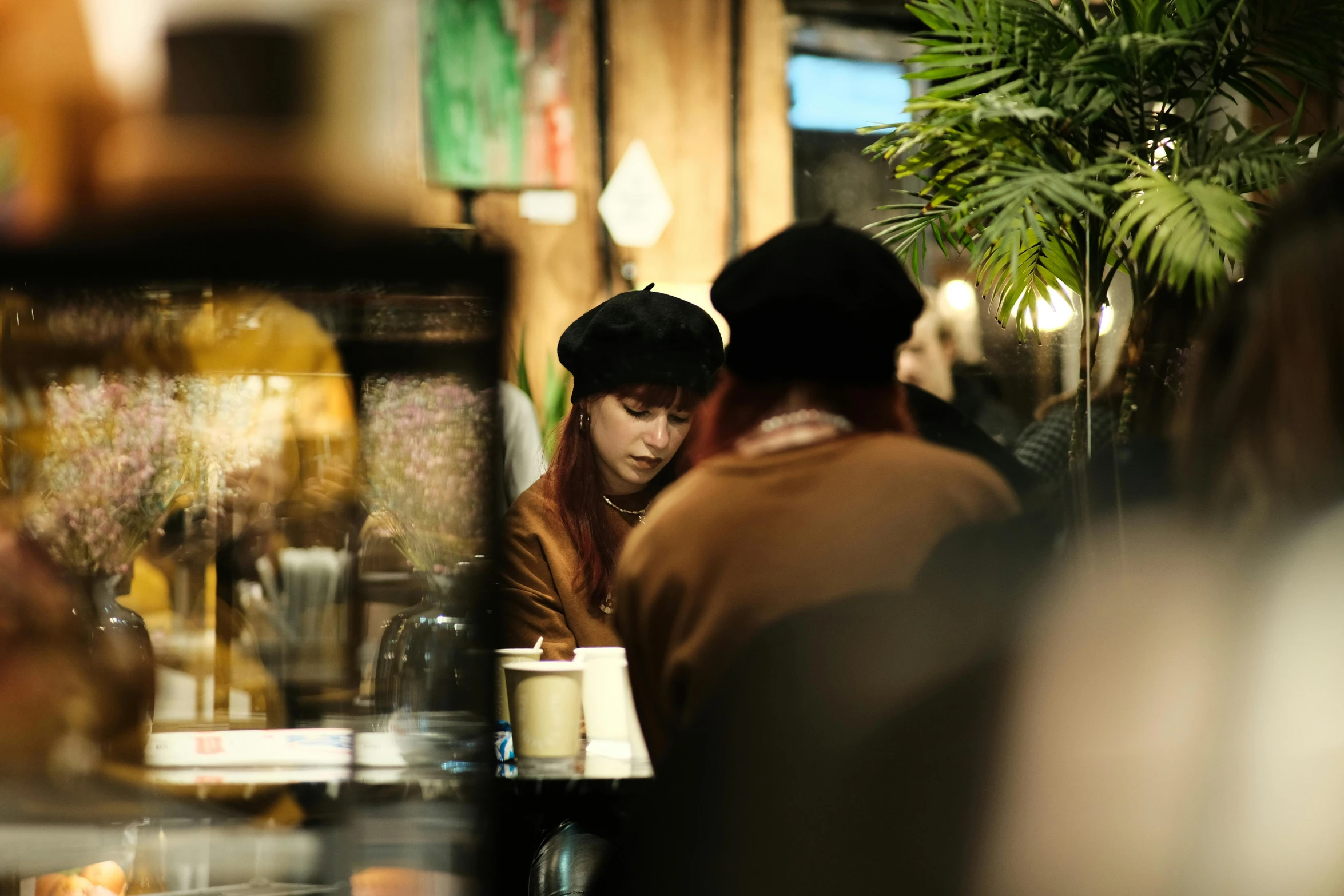 two people sitting together in a restaurant