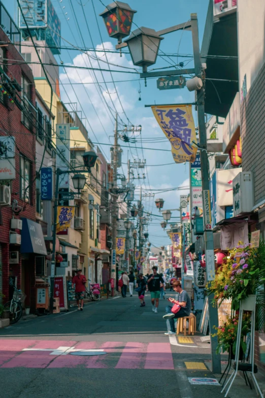 a city street filled with shops next to tall buildings